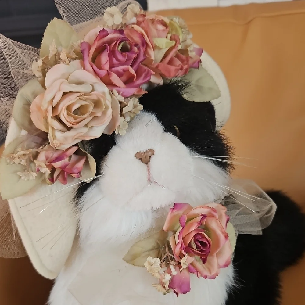 Black and White Plush Cat with flowered hat.